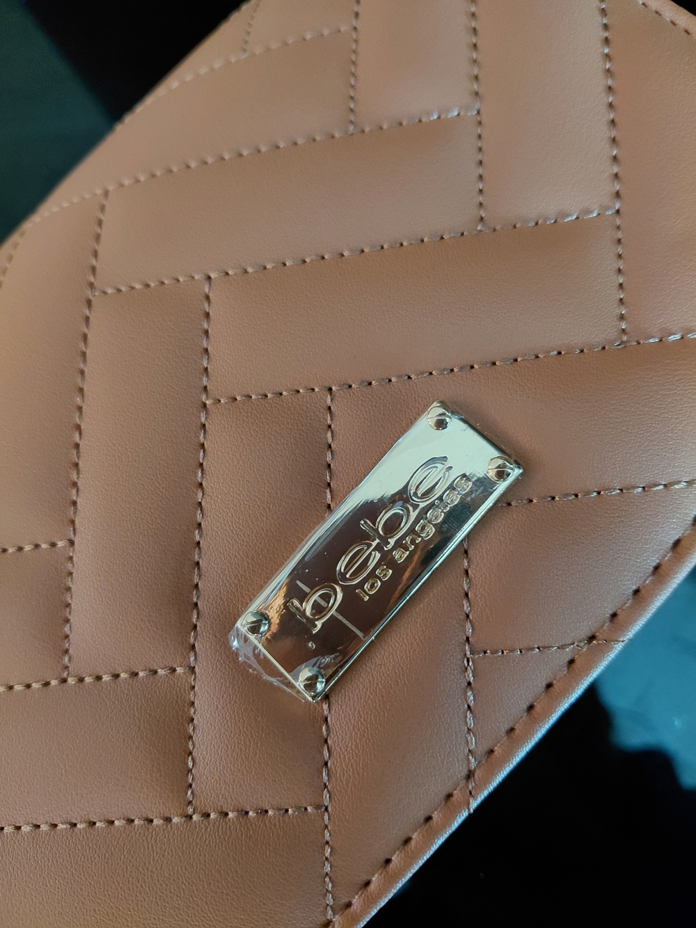 Bebe Quilted Faux Leather Clutch in Camel Brown with Gold Logo Plaque